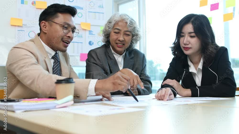 Asian business people meeting team working with accounting documents and laptop at the table in office, Happy team working and business training to technology concept, financial planning meeting. Asian business people meeting team working with accounting documents and laptop at the table in office, Happy team working and business training to technology concept, financial planning meeting.