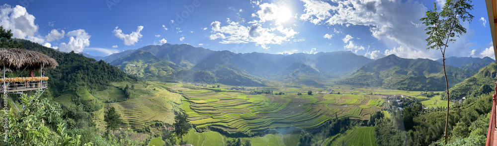 Beautiful panorama view point of rice fields on terraced of Tu Le in Vietnam with white clouds in blue sky. Vietnam landscape.
