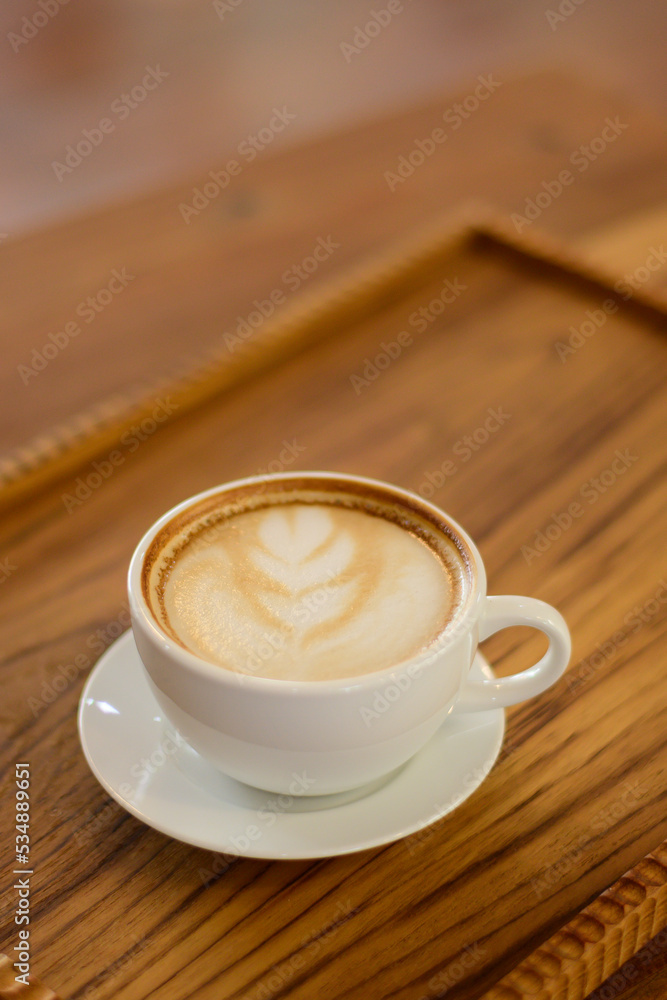 hot coffee latte Placed on a chopping board at a coffee shop in Chiang Mai, Thailand, on 29.92.2022.