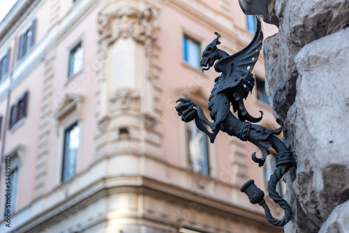 Old Candle Holder in the Shape of a Dragon Hanged on the Corner of a Building in the Street in the Center of Rome