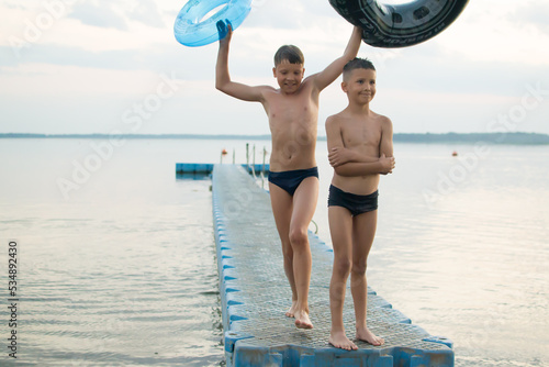  The brothers swim in the lake. Summer evening. Lake Myastro