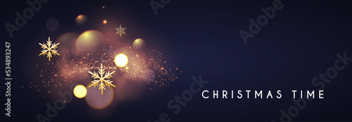 Christmas bokeh light effect with gold sowflakes.