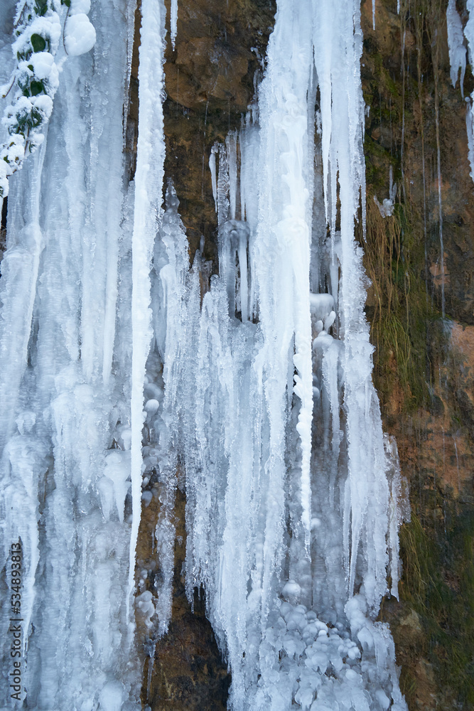 Icicles on the rock. Frozen waterfall in winter. Icicles on the rock. Frozen waterfall in winter.