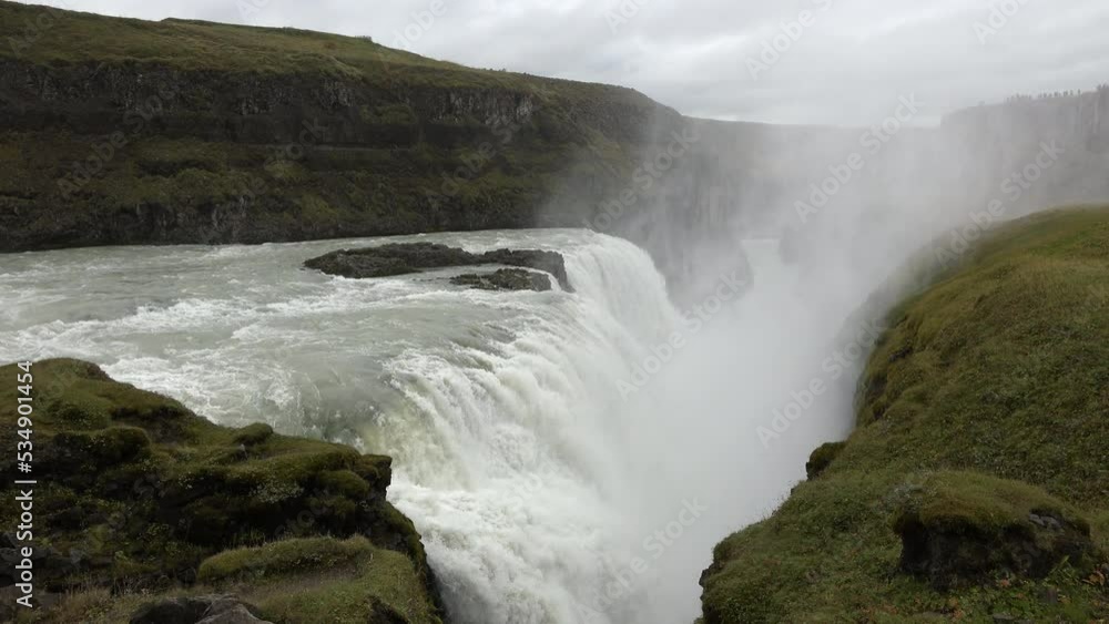 A picturesque waterfall in Iceland. This beautiful waterfall located in northeast Iceland is a tourist attraction that draws thousands of visitors each year. Ice cold water. A picturesque waterfall in Iceland. This beautiful waterfall located in northeast Iceland is a tourist attraction that draws thousands of visitors each year. Ice cold water.