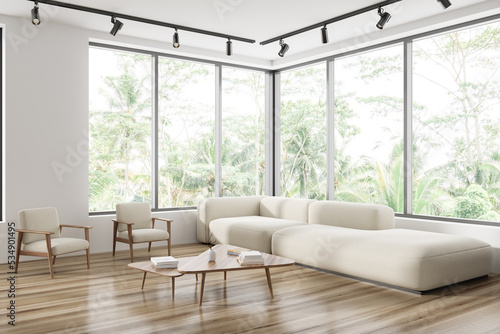 Light meeting room interior with couch and coffee table, panoramic window