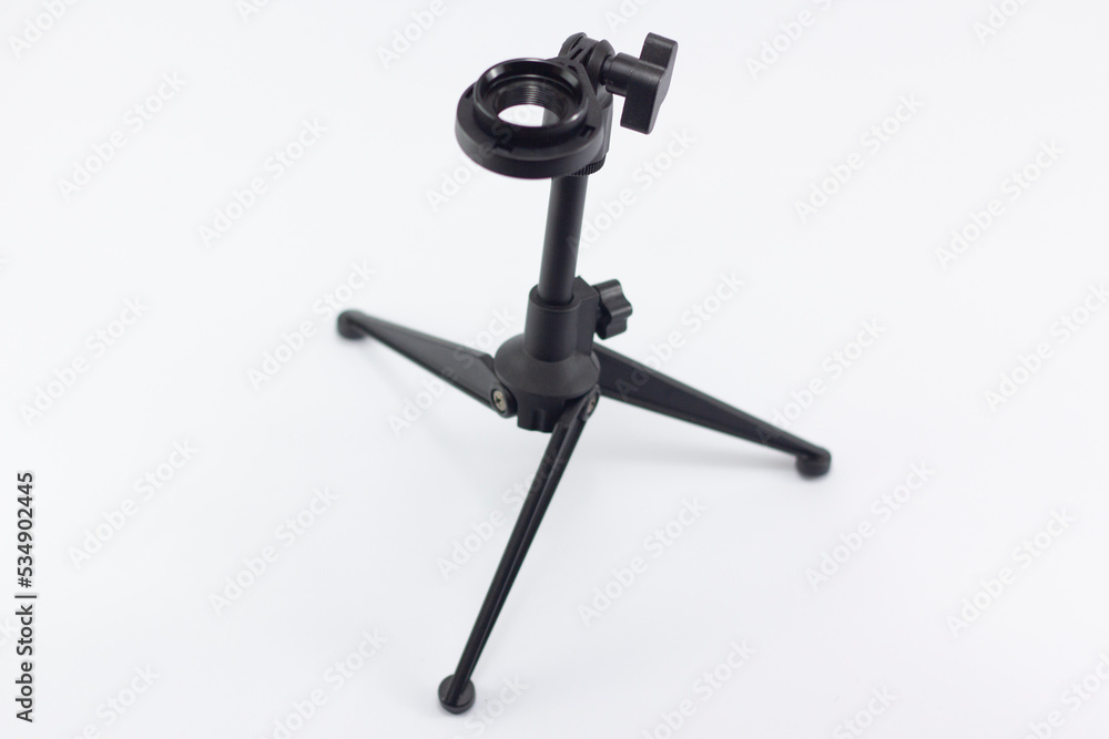 closeup black mini stand for micrphone, isolate at white background, you can put the microphone at the adjustable hole