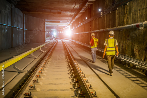 Soft focus and blurred lighting background of focus at  railway.Engineer or technician control. Underground tunnel infrastructure. Transport pipeline by Tunnel Boring Machine for electric train subway