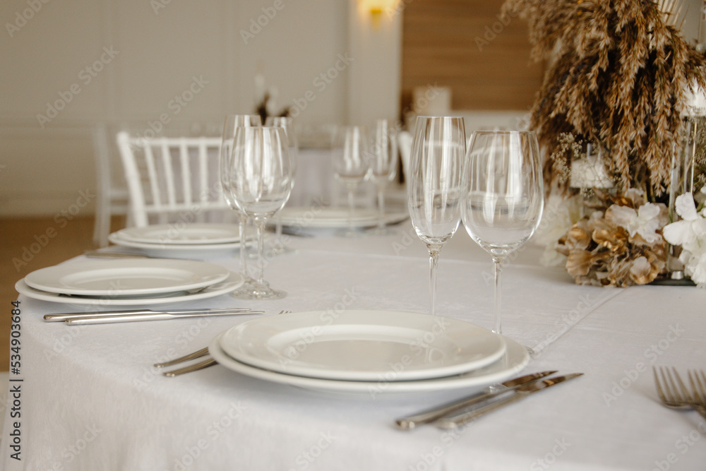 Served dinner table in a restaurant. Restaurant interior, table setting for a dinner, table set for a dinner.