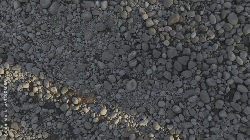 Textured Shot of Stones and Pebbles of a Dried River Flying Across with a Drone Textured Shot of Stones and Pebbles of a Dried River Flying Across with a Drone