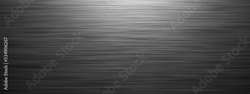 Brushed gray metal background, horizontal widescreen material wallpaper with lighting effect from above and copy space for text
