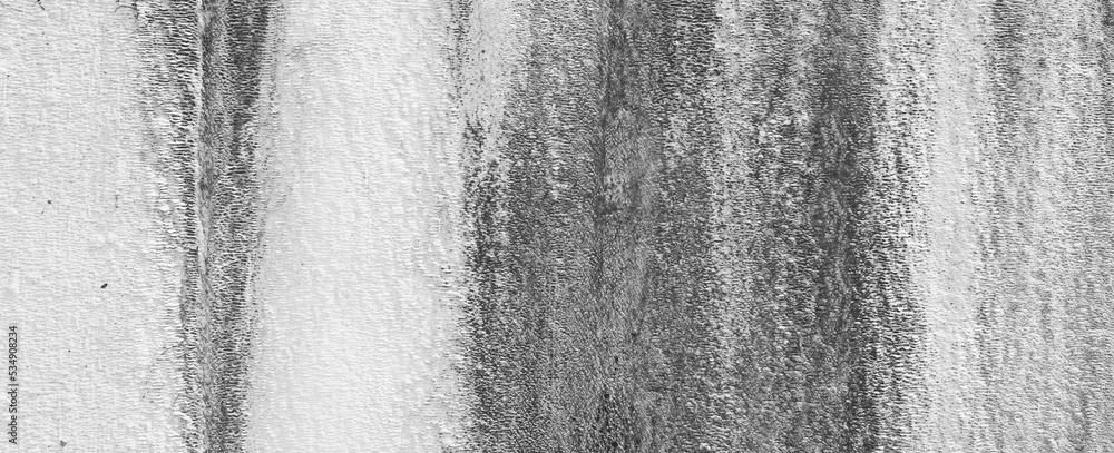 Streaks on a Pale White Plaster Wall. Rustic background. Panoramic Photo. Black and white Streaks on a Pale White Plaster Wall. Rustic background. Panoramic Photo. Black and white