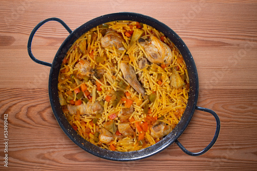 Paella with noodles, rabbit and vegetables. Tapa typical of the Spanish coast.
