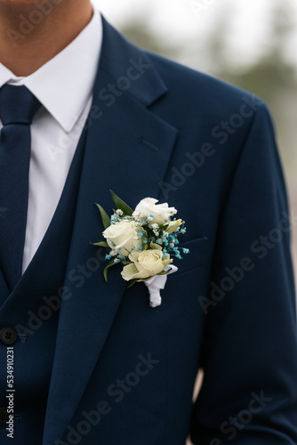 Boutonniere on the groom's blue jacket