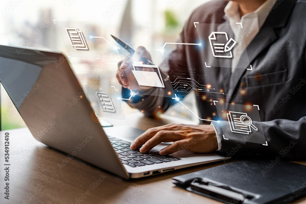 Businessman working and using a computer to manage online documentation ...