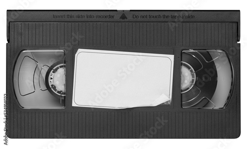 Old vintage vhs video cassette tape with a blank paper label. Magnetic videotape movie storage
