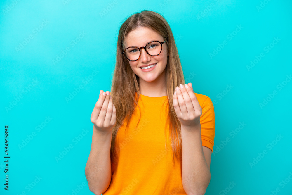 Young caucasian woman isolated on blue background making money gesture Young caucasian woman isolated on blue background making money gesture