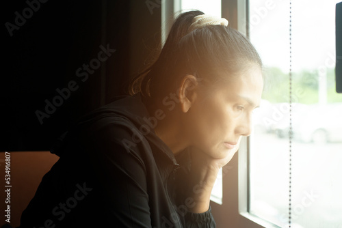 Принти на полотні Sad Mature Woman Suffering From Agoraphobia Looking Out Of Window