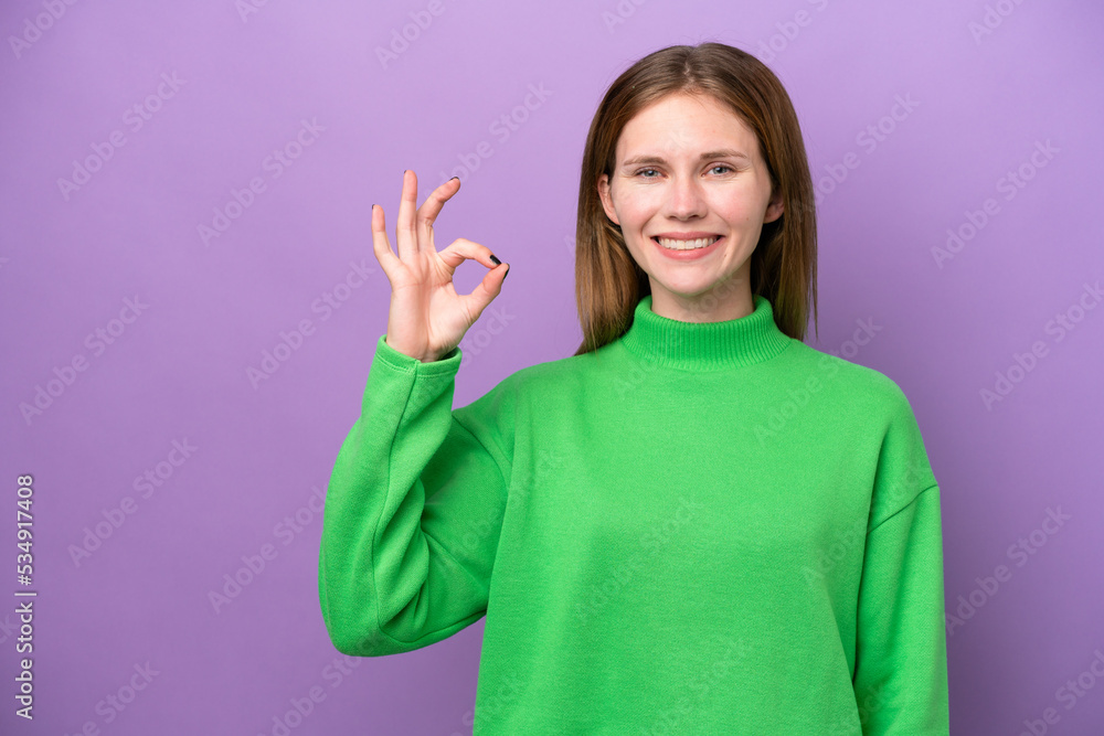 Young English woman isolated on purple background showing ok sign with fingers Young English woman isolated on purple background showing ok sign with fingers