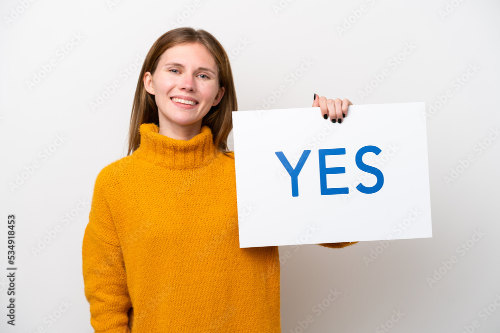 Young English woman isolated on white background holding a placard with text YES with happy expression Young English woman isolated on white background holding a placard with text YES with happy expression