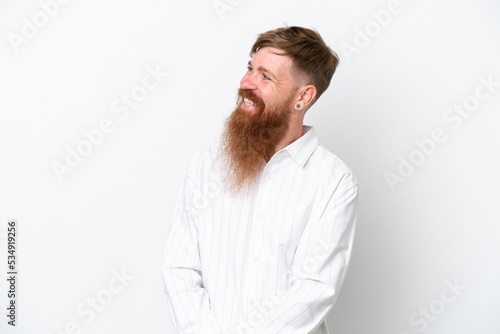 Redhead man with long beard isolated on white background looking to the side and smiling