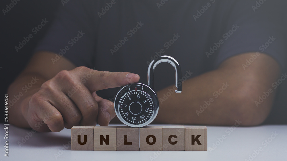 Security concept, man pointing unlock combination padlock.