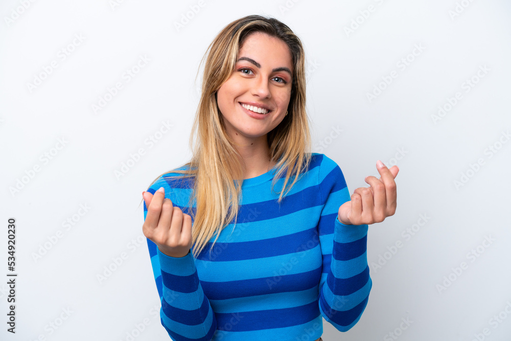 Fototapeta premium Young caucasian woman isolated on white background making money gesture