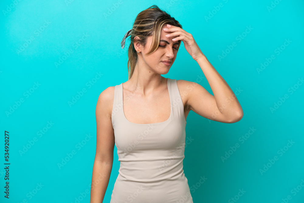 Young caucasian woman isolated on blue background with headache Young caucasian woman isolated on blue background with headache