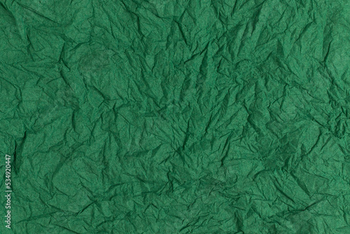 Green crumpled paper background. Full frame texture.