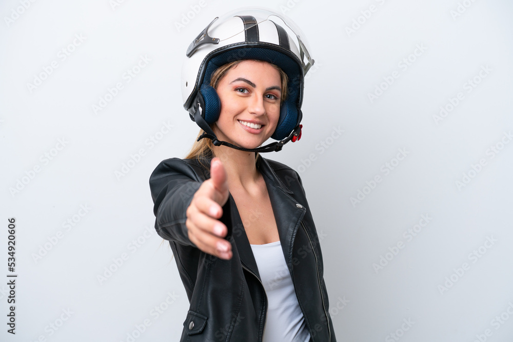 Young caucasian woman with a motorcycle helmet isolated on white background shaking hands for closing a good deal Young caucasian woman with a motorcycle helmet isolated on white background shaking hands for closing a good deal