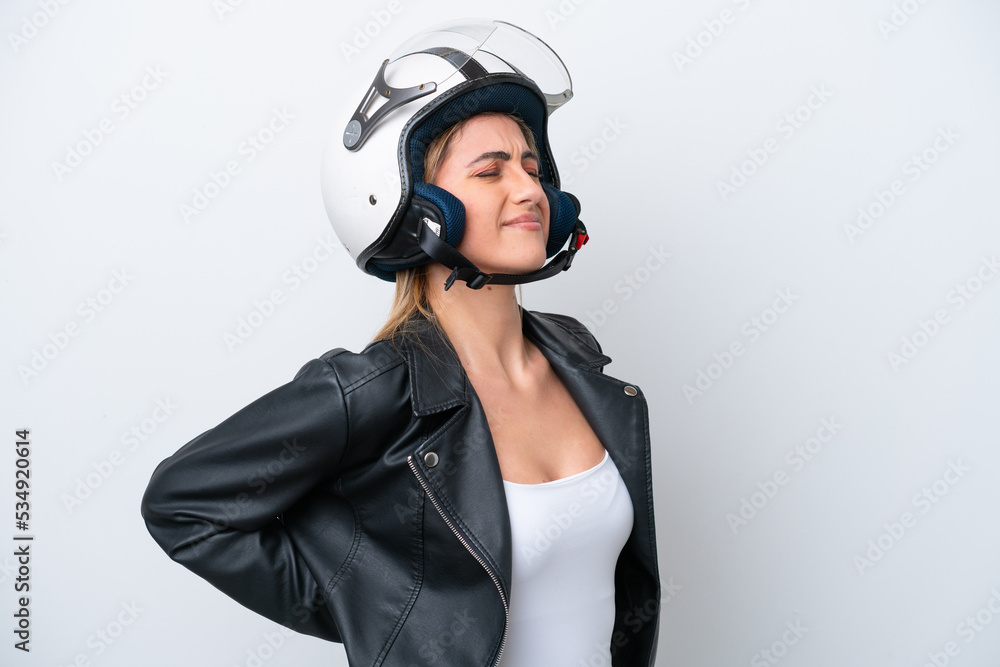Young caucasian woman with a motorcycle helmet isolated on white background suffering from backache for having made an effort Young caucasian woman with a motorcycle helmet isolated on white background suffering from backache for having made an effort