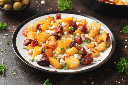 Photos Chorizo potato hash breakfast with eggs and feta cheese