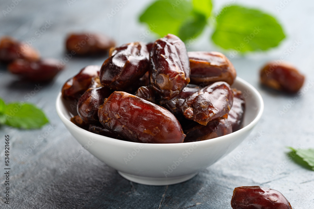 Organic dried Dates fruit in white bowl Organic dried Dates fruit in white bowl