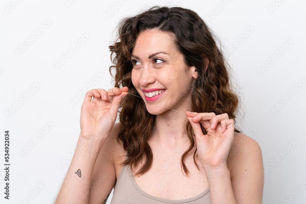 Young caucasian woman isolated on white background with dental floss. Close up portrait Young caucasian woman isolated on white background with dental floss. Close up portrait