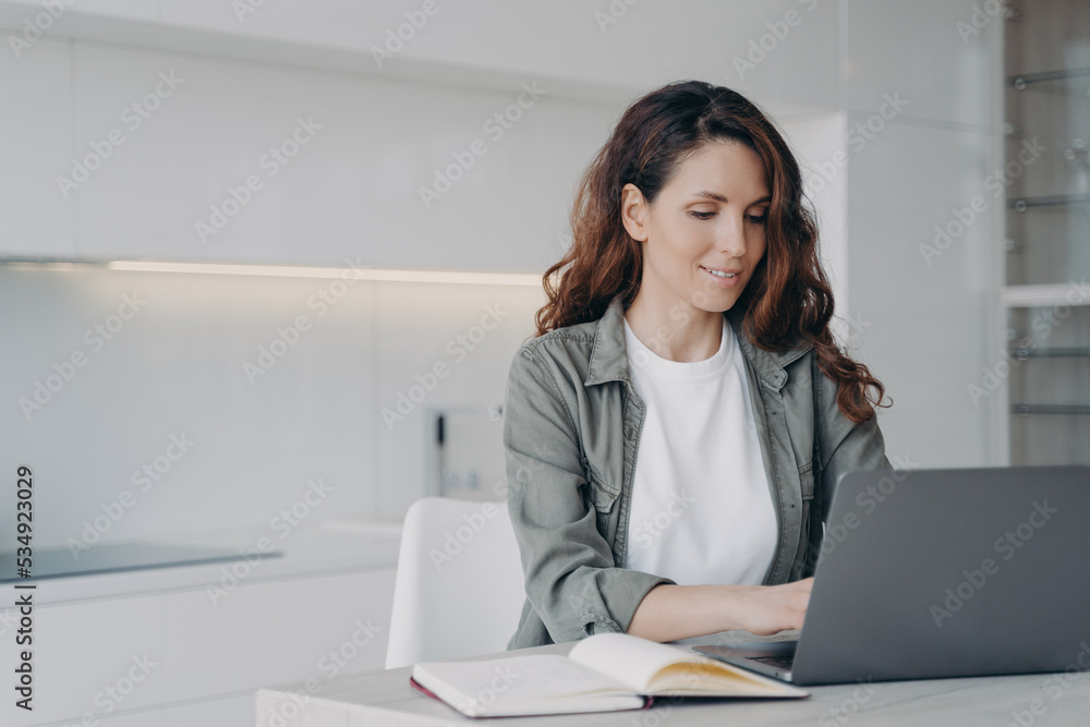 Hispanic woman working or learning online at laptop at home. Remote job or education, elearning Hispanic woman working or learning online at laptop at home. Remote job or education, elearning