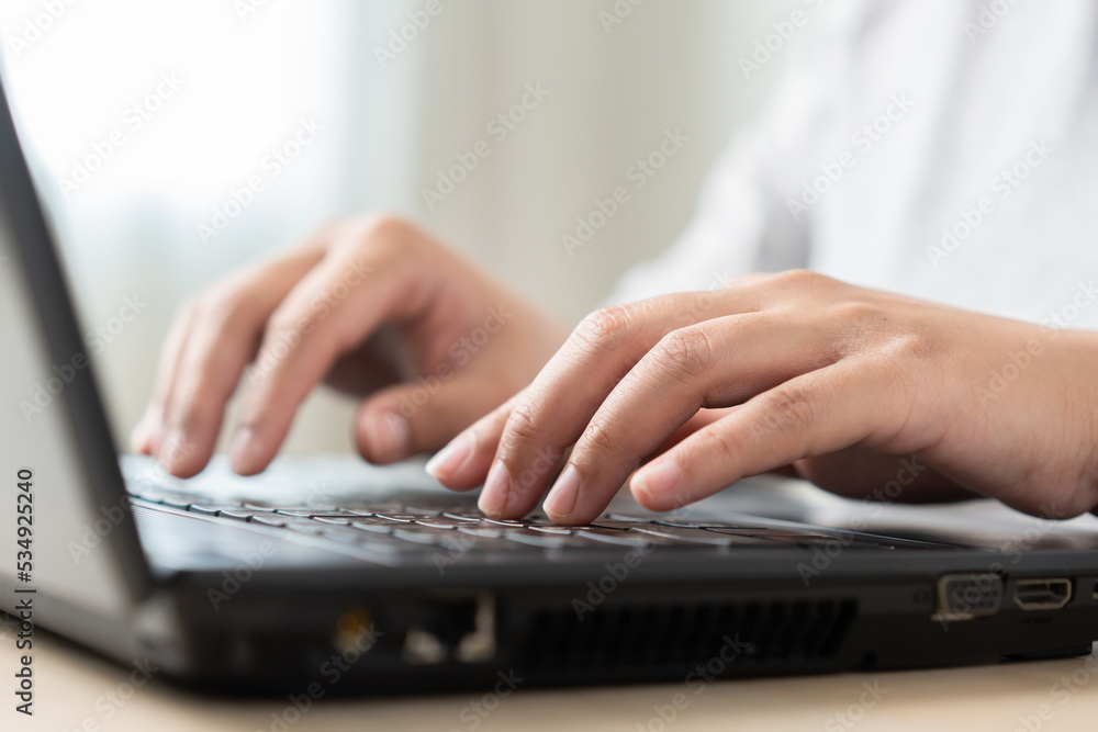 Woman using laptop working as typing, searching, or messaging online networking Woman using laptop working as typing, searching, or messaging online networking