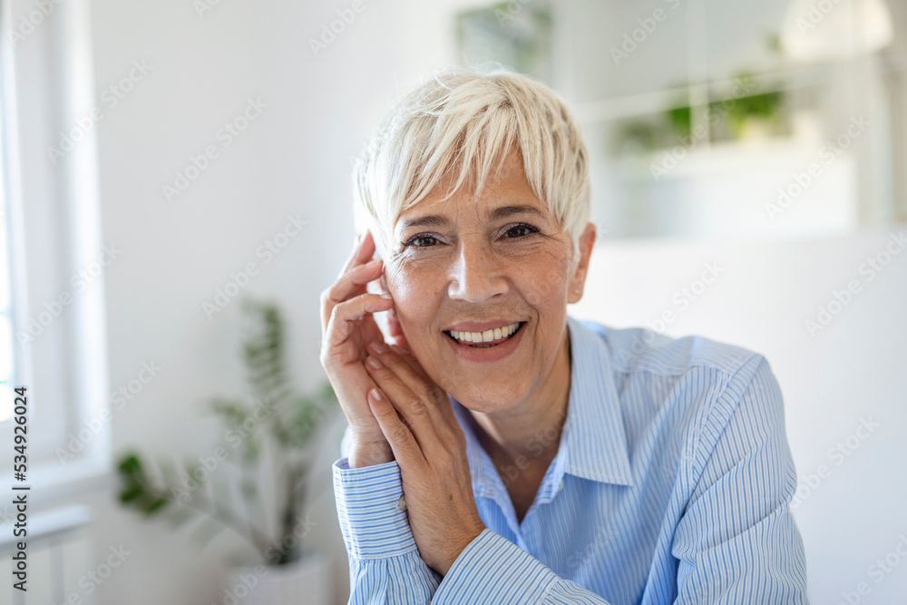 Senior woman looking at camera. Successful mature business woman . Happy old professor in standing in office with gray hair. Senior woman looking at camera. Successful mature business woman . Happy old professor in standing in office with gray hair.