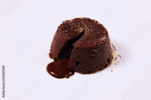 Delicious fondant with hot chocolate on white plate. Lava cake. Chocolate cake with clipping path. Molten chocolate cake. Side view