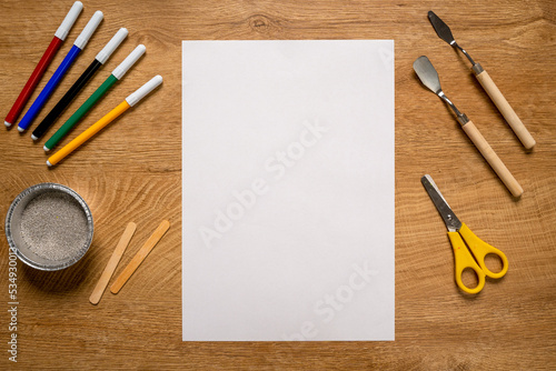 Desk with white paper and art tools ready to use, artist desk