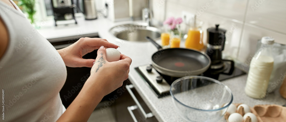 Cropped of girl holding egg near at kitchen Cropped of girl holding egg near at kitchen