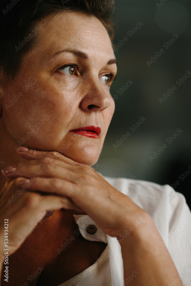 A mature woman poses in a film studio. Emotional portrait of the actress. A mature woman poses in a film studio. Emotional portrait of the actress.