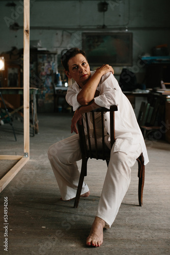 Portrait of a woman in a film studio with lighting equipment.