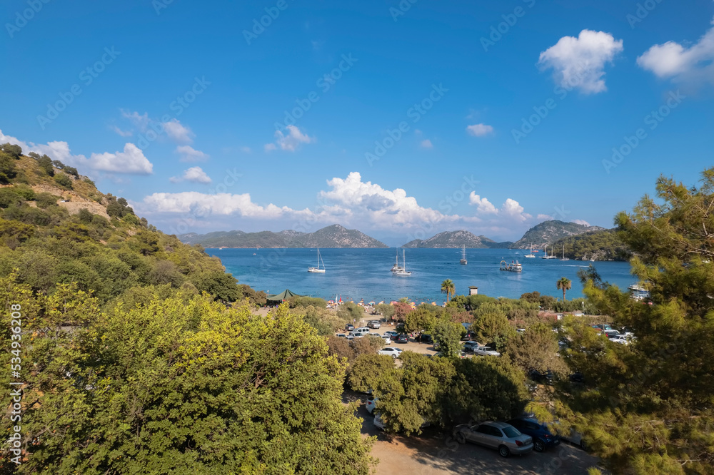 Fototapeta premium sarsala beach bay dalaman Mediterranean bay with hills and pine forest blue water and boats