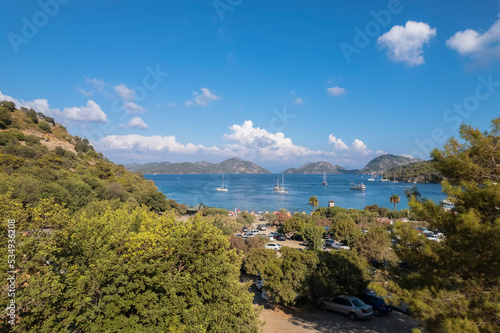 sarsala beach bay dalaman Mediterranean bay with hills and pine forest blue water and boats