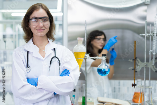 Medical scientists working with scientific equipment in the laboratory. Female scientist doing analysis liquid in glassware tube in the lab office