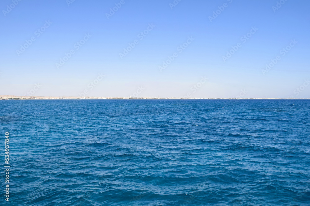 Vacation, travel, holiday, trip to Egypt. View from Red sea to coast against clear blue sky. Peaceful seascape. Copy space. Selective focus.