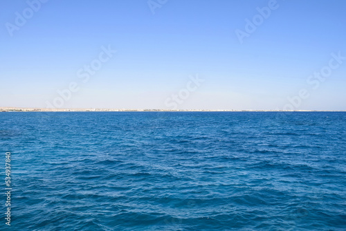 Vacation, travel, holiday, trip to Egypt. View from Red sea to coast against clear blue sky. Peaceful seascape. Copy space. Selective focus. © Marina_Nov