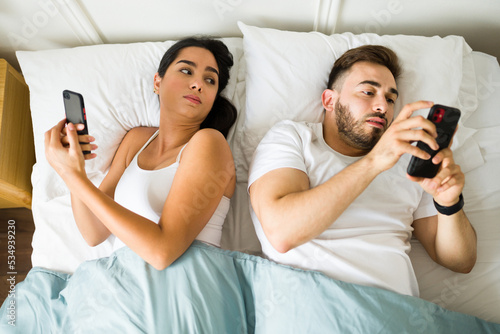 Girlfriend feeling jealous about his boyfriend texting on his phone