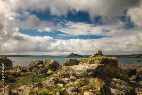 St Michael's Mount seen from the rocky Cornish coast.