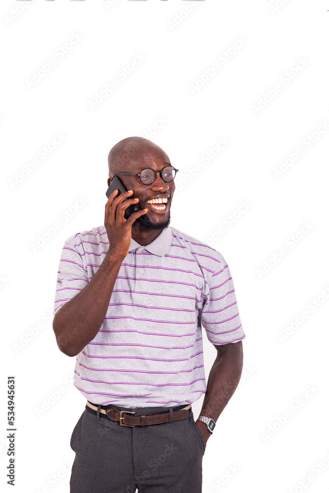 young man talking on mobile phone while smiling. young man talking on mobile phone while smiling.