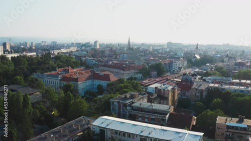 Aerial footage of Novi Sad city withhouse roofs and church in fog. Modern city landmark in winter photo